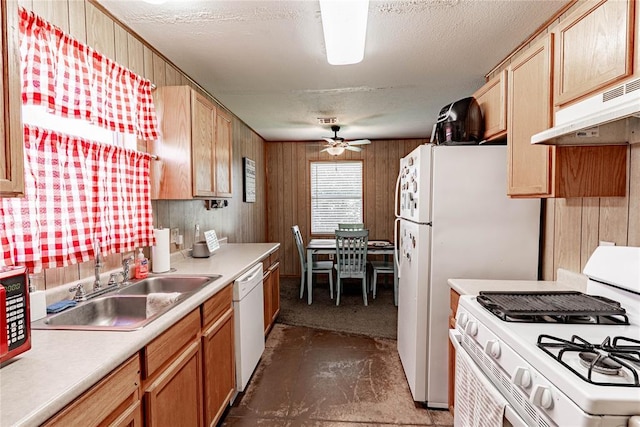 1343 E Moses St, Cushing, OK 74023 - kitchen featuring white appliances, ceiling fan, under cabinet range hood, wood walls, and light countertops