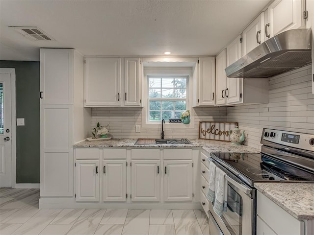 2417 SW 47th St, Oklahoma City, OK 73129 - kitchen with stainless steel electric range oven, under cabinet range hood, a sink, white cabinets, and recessed lighting
