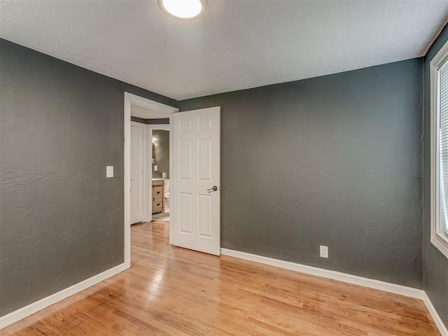 2417 SW 47th St, Oklahoma City, OK 73129 - spare room with light wood-style floors, baseboards, and a textured wall