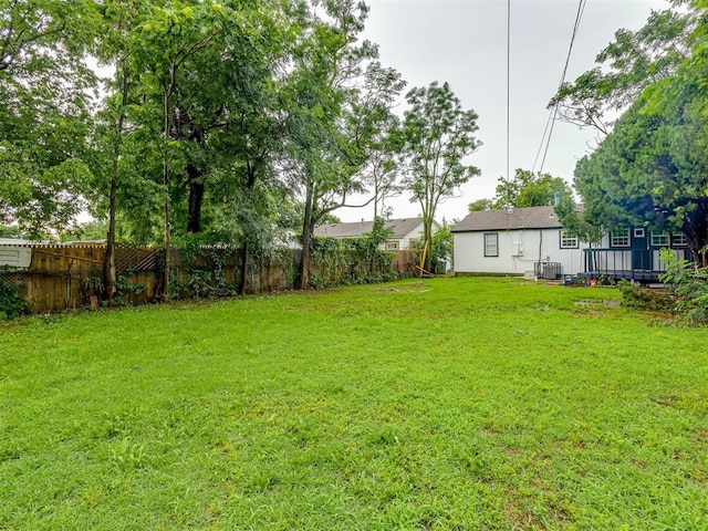 2417 SW 47th St, Oklahoma City, OK 73129 - view of yard with central AC unit and a wooden deck