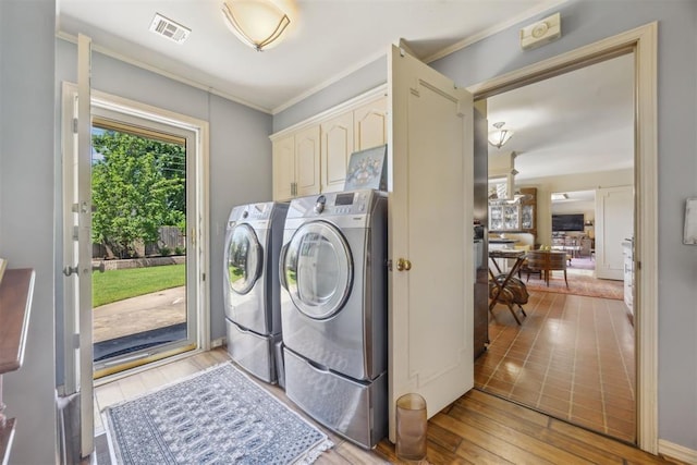 2917 W Pelham Dr, Oklahoma City, OK 73120 - laundry area with cabinet space, separate washer and dryer, light wood-style floors, and ornamental molding