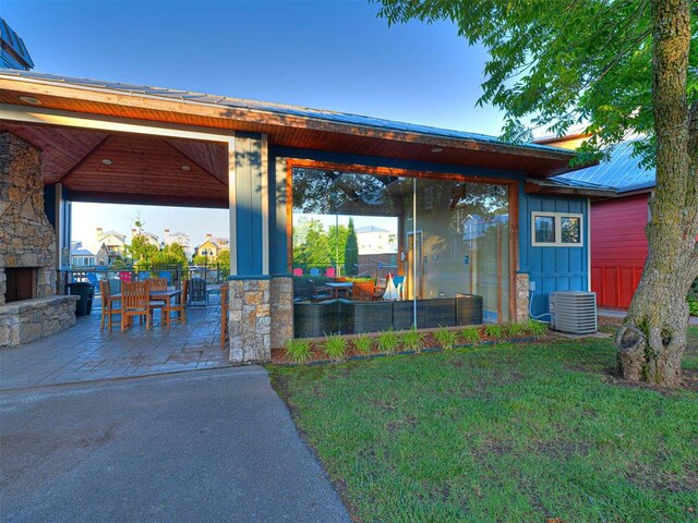 37271 S Cliff Crest Dr, Langley, OK 74301 - view of patio / terrace with central AC and an outdoor stone fireplace