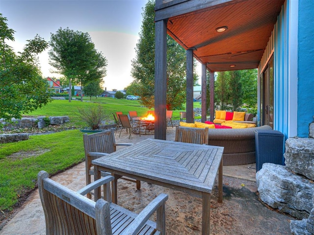 37271 S Cliff Crest Dr, Langley, OK 74301 - patio terrace at dusk featuring an outdoor living space with a fire pit, a patio, and a lawn