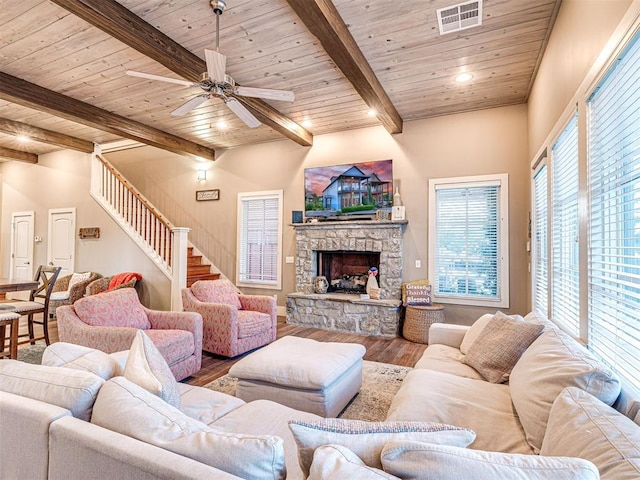 37271 S Cliff Crest Dr, Langley, OK 74301 - living room with wood ceiling with exposed beams, wood finished floors, stairs, a stone fireplace, and ceiling fan