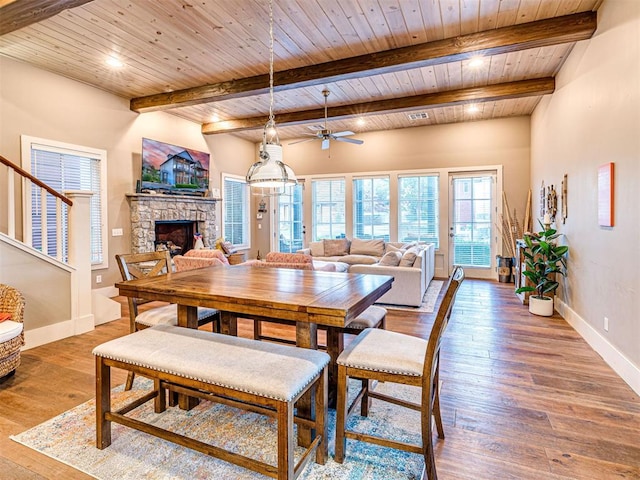 37271 S Cliff Crest Dr, Langley, OK 74301 - dining area with a stone fireplace, wood ceiling with exposed beams, ceiling fan, wood-type flooring, and baseboards
