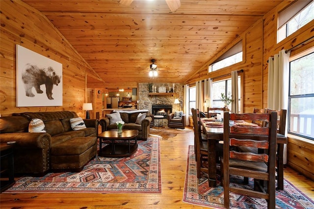 1073 Southern Hills Cir, Broken Bow, OK 74728 - living area with ceiling fan, lofted ceiling, plenty of natural light, hardwood / wood-style flooring, and wooden walls