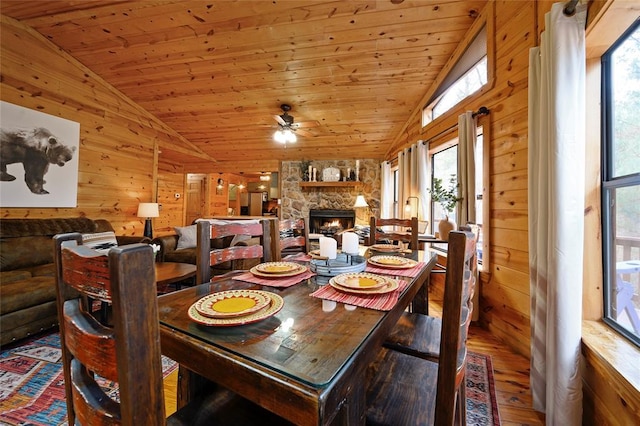 1073 Southern Hills Cir, Broken Bow, OK 74728 - dining area with vaulted ceiling, a ceiling fan, hardwood / wood-style floors, wooden walls, and a fireplace