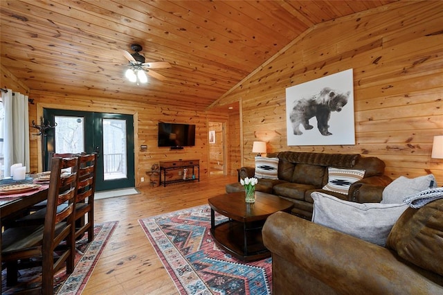 1073 Southern Hills Cir, Broken Bow, OK 74728 - living room featuring lofted ceiling, healthy amount of natural light, wooden walls, a ceiling fan, and wood ceiling