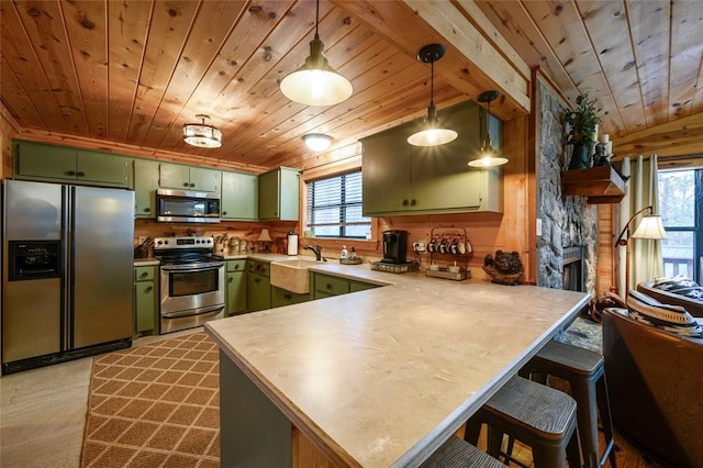 1073 Southern Hills Cir, Broken Bow, OK 74728 - kitchen with stainless steel appliances, green cabinetry, wooden ceiling, a peninsula, and healthy amount of natural light