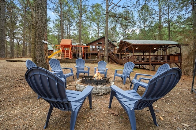 1073 Southern Hills Cir, Broken Bow, OK 74728 - view of patio / terrace featuring a fire pit, a wooden deck, and a playground