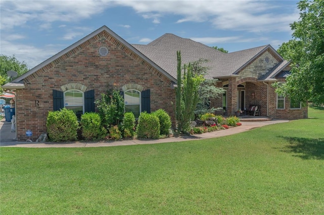 108 Raye Pl, Tuttle, OK 73089 - french provincial home with brick siding, a front lawn, and a shingled roof