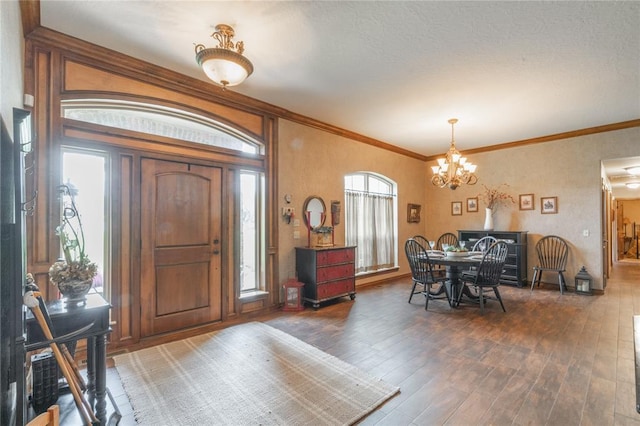 108 Raye Pl, Tuttle, OK 73089 - entryway with a chandelier, wood finished floors, and ornamental molding
