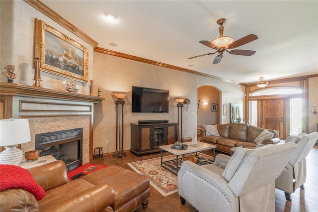 108 Raye Pl, Tuttle, OK 73089 - living area featuring a fireplace, arched walkways, wood finished floors, crown molding, and ceiling fan