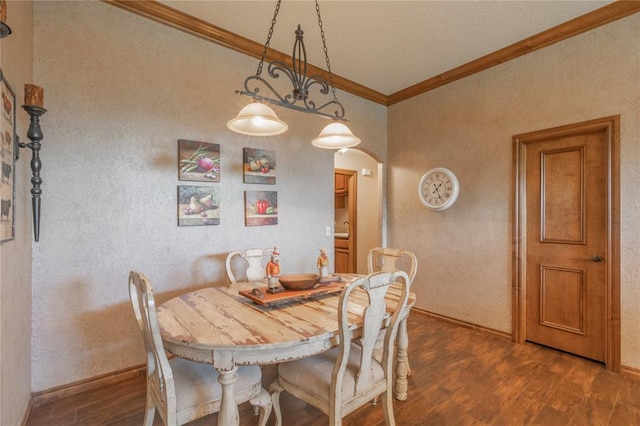 108 Raye Pl, Tuttle, OK 73089 - dining room with ornamental molding, dark wood finished floors, arched walkways, and baseboards