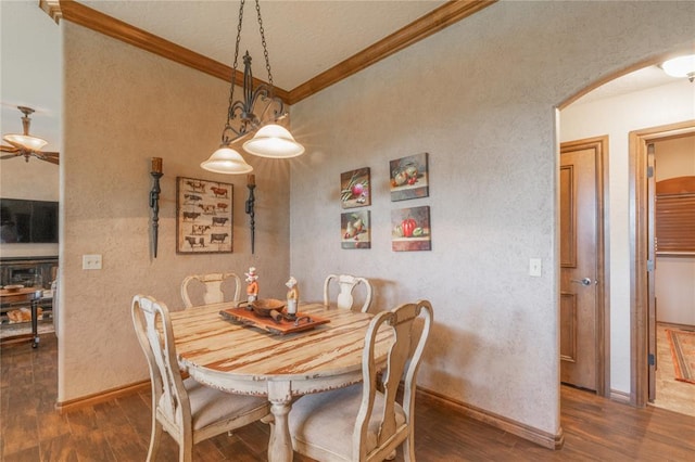108 Raye Pl, Tuttle, OK 73089 - dining room featuring arched walkways, ornamental molding, dark wood-style floors, a textured wall, and baseboards