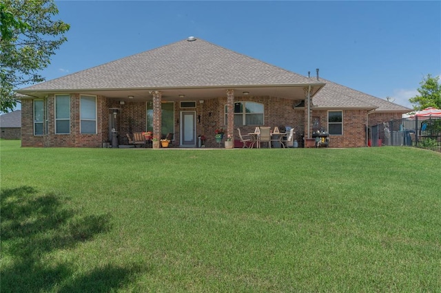 108 Raye Pl, Tuttle, OK 73089 - back of house featuring brick siding and roof with shingles