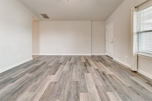 15108 Coldsun Dr, Oklahoma City, OK 73170 - spare room featuring light wood-style floors and vaulted ceiling