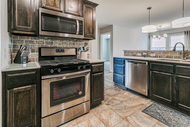 15108 Coldsun Dr, Oklahoma City, OK 73170 - kitchen featuring stainless steel appliances, backsplash, light countertops, and a chandelier