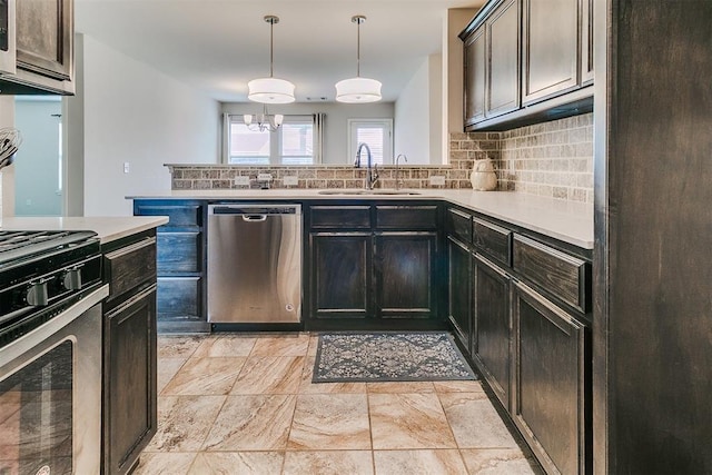15108 Coldsun Dr, Oklahoma City, OK 73170 - kitchen featuring appliances with stainless steel finishes, decorative backsplash, light countertops, and pendant lighting