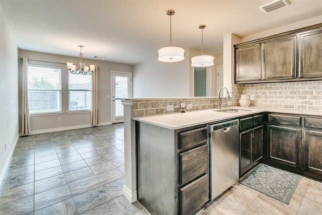 15108 Coldsun Dr, Oklahoma City, OK 73170 - kitchen with stainless steel dishwasher, decorative backsplash, a chandelier, a peninsula, and light countertops