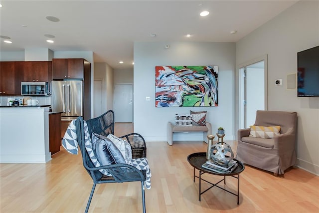 301 NE 4th St Unit 10, Oklahoma City, OK 73104 - living room with light wood-style flooring, recessed lighting, and baseboards