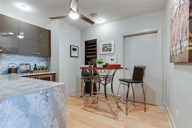 301 NE 4th St Unit 10, Oklahoma City, OK 73104 - dining room with light wood-type flooring, a ceiling fan, and baseboards