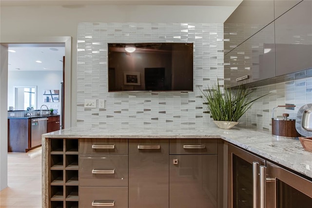 301 NE 4th St Unit 10, Oklahoma City, OK 73104 - bar with stainless steel dishwasher, beverage cooler, backsplash, and a sink