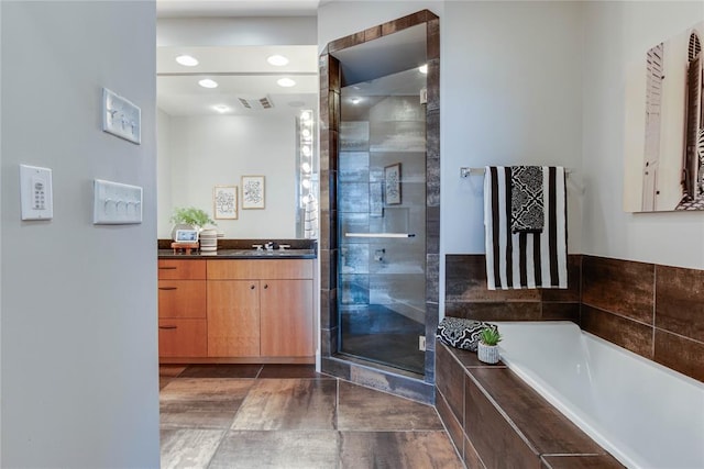 301 NE 4th St Unit 10, Oklahoma City, OK 73104 - full bath featuring vanity, a garden tub, and a stall shower