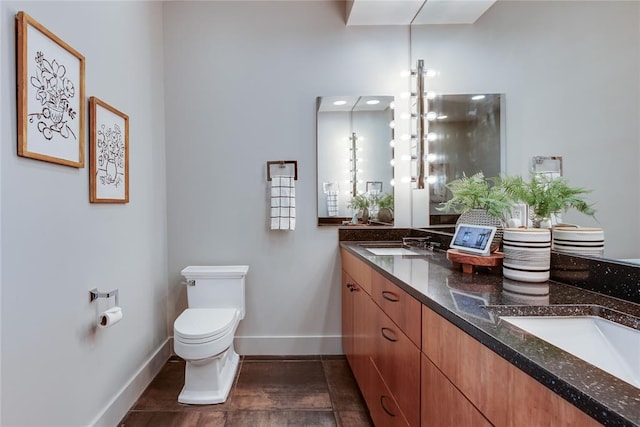 301 NE 4th St Unit 10, Oklahoma City, OK 73104 - full bath featuring double vanity, baseboards, and toilet