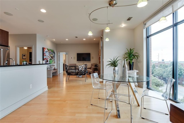 301 NE 4th St Unit 10, Oklahoma City, OK 73104 - dining room featuring light wood-style flooring and recessed lighting