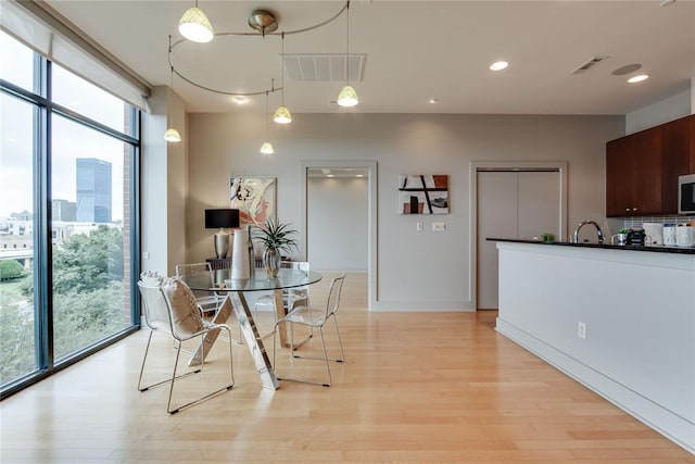 301 NE 4th St Unit 10, Oklahoma City, OK 73104 - dining space featuring healthy amount of natural light, light wood-type flooring, and recessed lighting