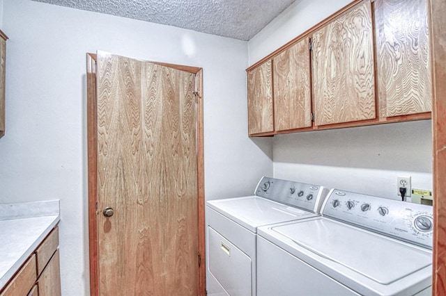 2804 Meadow Ave, Norman, OK 73072 - laundry room with separate washer and dryer, cabinet space, and a textured ceiling