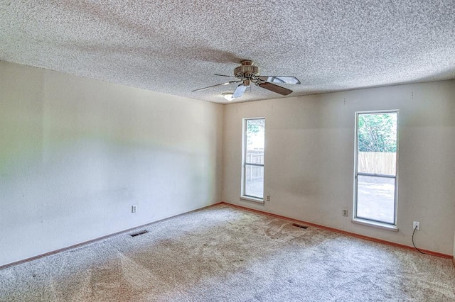 2804 Meadow Ave, Norman, OK 73072 - carpeted spare room featuring healthy amount of natural light, baseboards, a ceiling fan, and a textured ceiling
