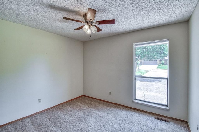 2804 Meadow Ave, Norman, OK 73072 - spare room with carpet flooring, ceiling fan, a textured ceiling, and baseboards
