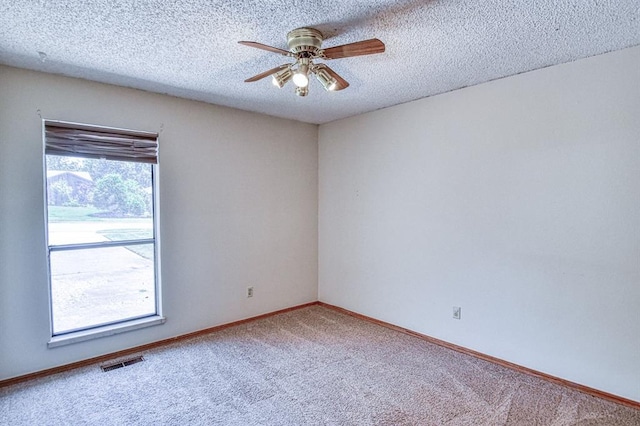2804 Meadow Ave, Norman, OK 73072 - carpeted empty room featuring ceiling fan, baseboards, and a textured ceiling