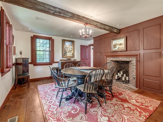 4005 NE 122nd St, Edmond, OK 73013 - dining area with hardwood / wood-style floors, a chandelier, beam ceiling, and a brick fireplace
