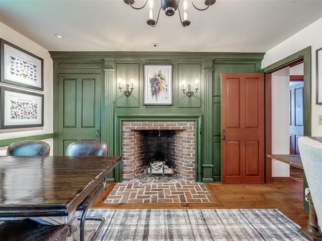 4005 NE 122nd St, Edmond, OK 73013 - living room featuring a chandelier, a fireplace, and a decorative wall