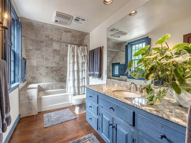 4005 NE 122nd St, Edmond, OK 73013 - bathroom with vanity, wood finished floors, shower / tub combo, and a tiled fireplace