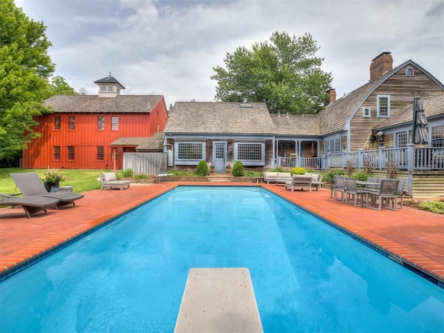 4005 NE 122nd St, Edmond, OK 73013 - outdoor pool with a diving board and a patio