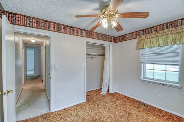 342 W Birch Dr, Mustang, OK 73064 - unfurnished bedroom featuring a textured ceiling, carpet floors, a closet, and a ceiling fan