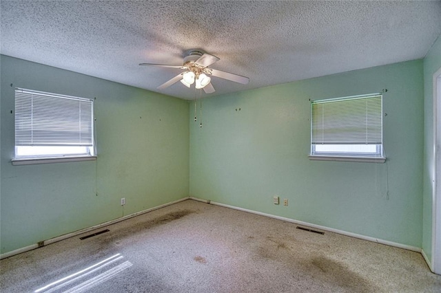 342 W Birch Dr, Mustang, OK 73064 - carpeted spare room with healthy amount of natural light, a ceiling fan, and a textured ceiling