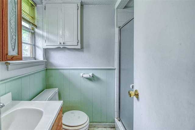 342 W Birch Dr, Mustang, OK 73064 - bathroom with a stall shower, vanity, and wainscoting