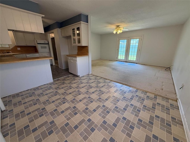 342 W Birch Dr, Mustang, OK 73064 - kitchen featuring oven, ceiling fan, open floor plan, french doors, and a peninsula