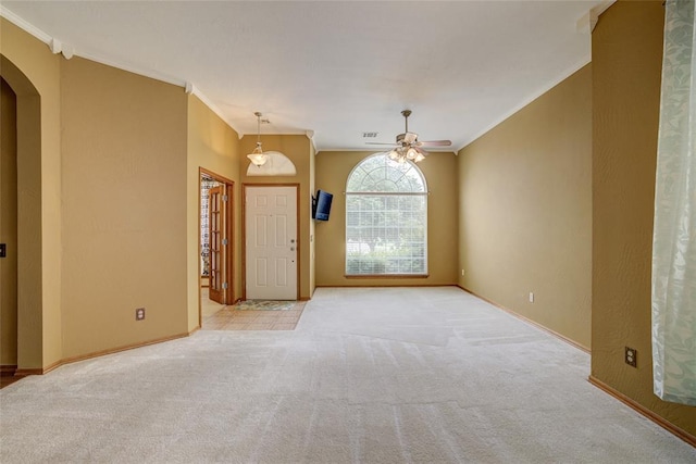 913 Elm Creek Dr, Moore, OK 73160 - carpeted spare room with arched walkways, crown molding, a ceiling fan, and baseboards