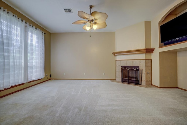913 Elm Creek Dr, Moore, OK 73160 - unfurnished living room with a ceiling fan, carpet floors, baseboards, and a tiled fireplace