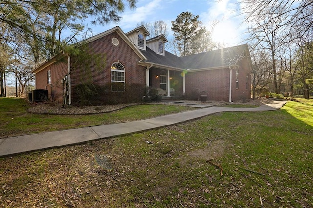 262 Shrouder Rd, Broken Bow, OK 74728 - view of front of house with brick siding, central AC, and a front yard