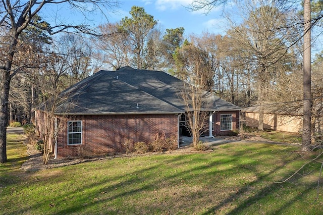 262 Shrouder Rd, Broken Bow, OK 74728 - rear view of property featuring brick siding, a lawn, and roof with shingles