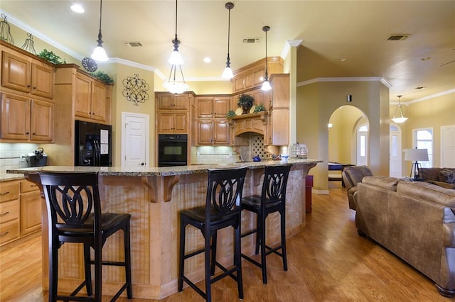 262 Shrouder Rd, Broken Bow, OK 74728 - kitchen with arched walkways, black appliances, light stone counters, tasteful backsplash, and crown molding
