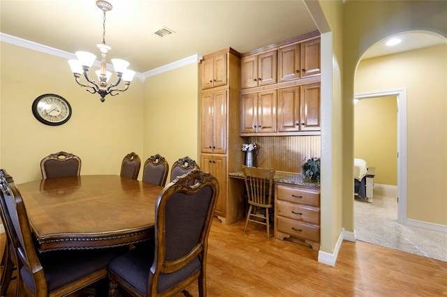 262 Shrouder Rd, Broken Bow, OK 74728 - dining room featuring arched walkways, a chandelier, crown molding, light wood-type flooring, and baseboards