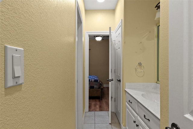 262 Shrouder Rd, Broken Bow, OK 74728 - ensuite bathroom with tile patterned flooring, vanity, and a textured wall
